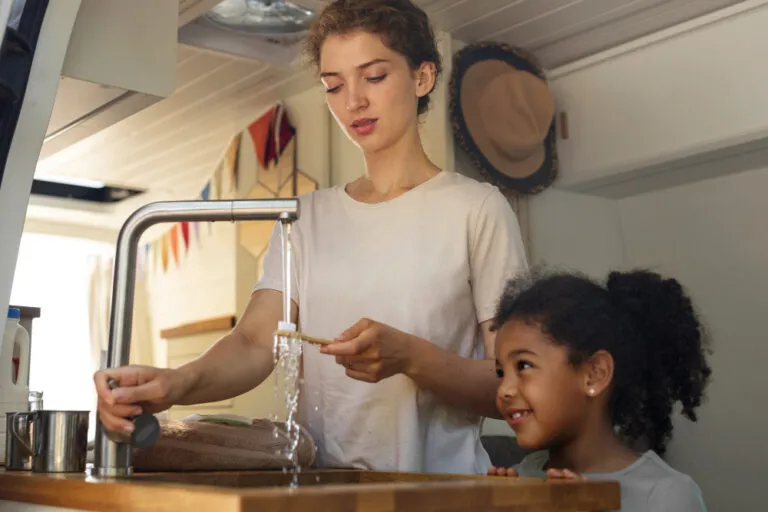 Family using hot water from tap with consistent hot water supply