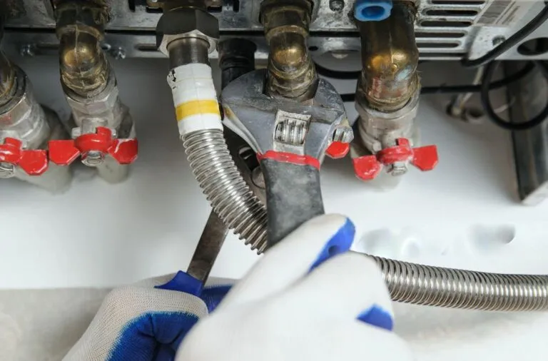 Plumber repairing water heater