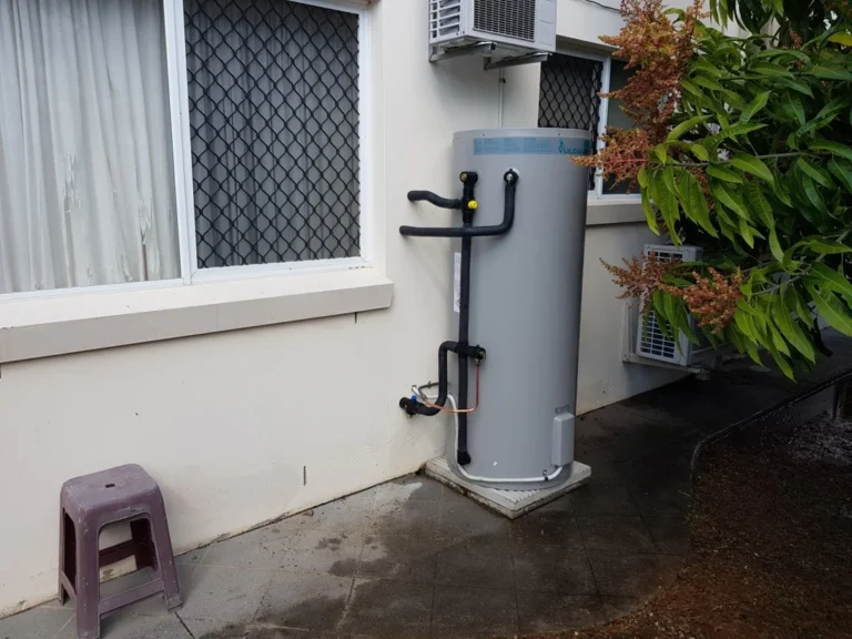 Vulcan hot water system installed outside a house near windows
